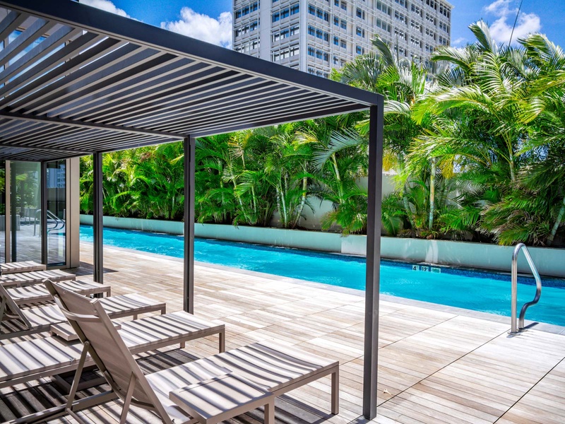 Relax under a stylish pergola by the pool, with comfy loungers and tropical foliage framing the skyline. After a dip, head to Waikiki Beach or fire up the building’s BBQ area. Shared with other residents.