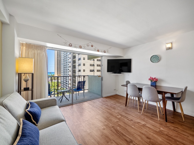 Relax, share a meal, or open a laptop in this flexible living area with comfortable seating, a four-person table, and direct lanai/balcony access—well suited to the everyday flow of a 30-night Waikiki stay.
