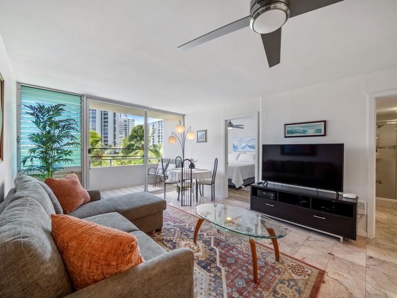 Relax together in a naturally lit living area that keeps the sectional, Smart TV, dining table, bedrooms, and lanai/balcony within easy reach throughout your extended Harbor View Plaza stay.