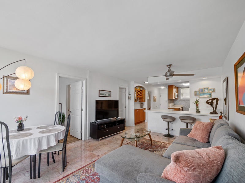 Share meals, stream a favorite show, or ease into a quiet evening in this comfortable open-plan living area, with dining, kitchen seating, and space to gather during an extended Waikiki stay.