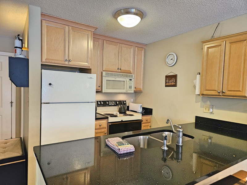 Full kitchen with 2nd bath beyond