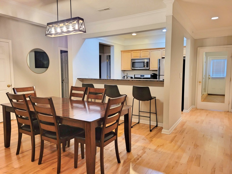 Dining area with kitchen easily accessible from entry