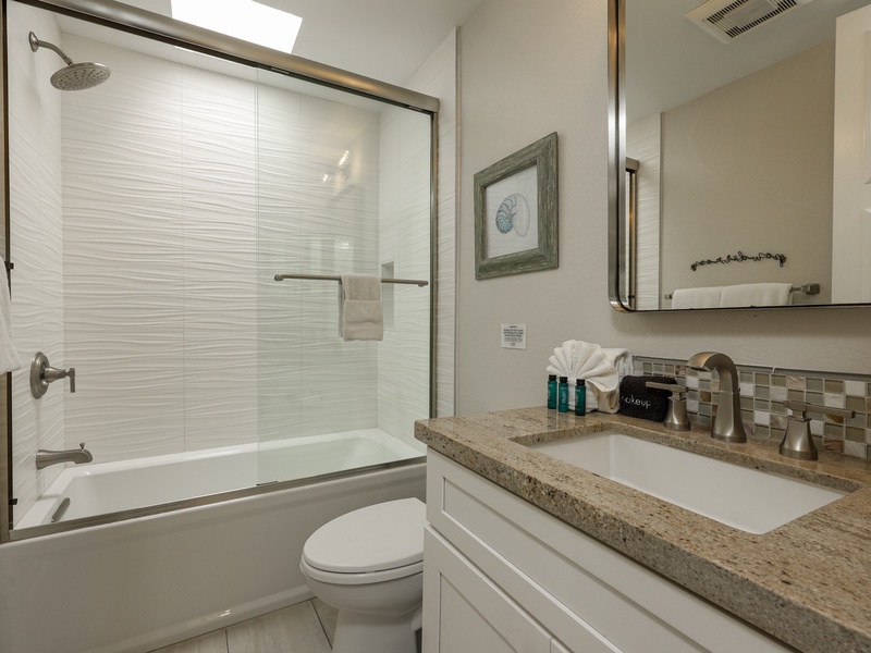 The secondary bathroom has a tub and shower combination