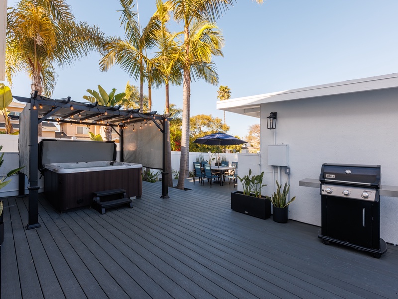 Enjoy the brand new deck, featuring a dining area, seating, a BBQ grill, and private hot tub.