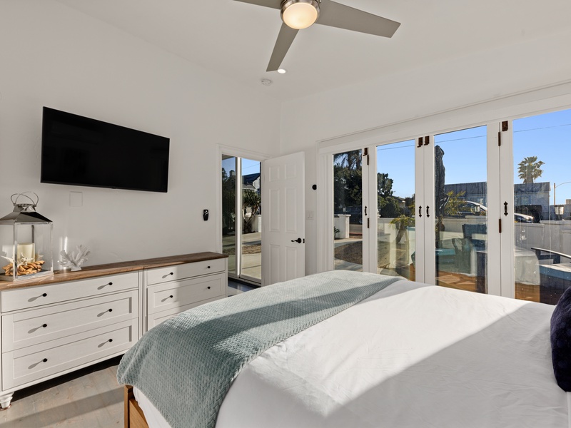 A guest bedroom offering patio access and a Queen bed. 