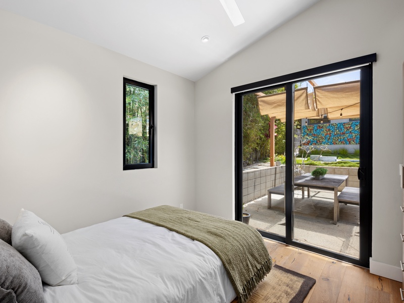 Guest bedroom with back patio access. 