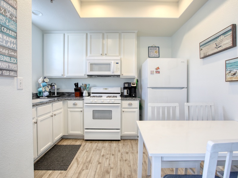 The fully equipped kitchen has a refrigerator, stove and oven, microwave, k-cup coffee maker, and dish ware—everything you need to whip up meals or enjoy a fresh cup of coffee before heading to the beach. 