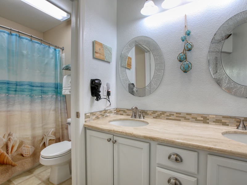 The bathroom includes a tub/shower combination, plush white towels, and complimentary bath soaps for a refreshing start or relaxing end to your day.