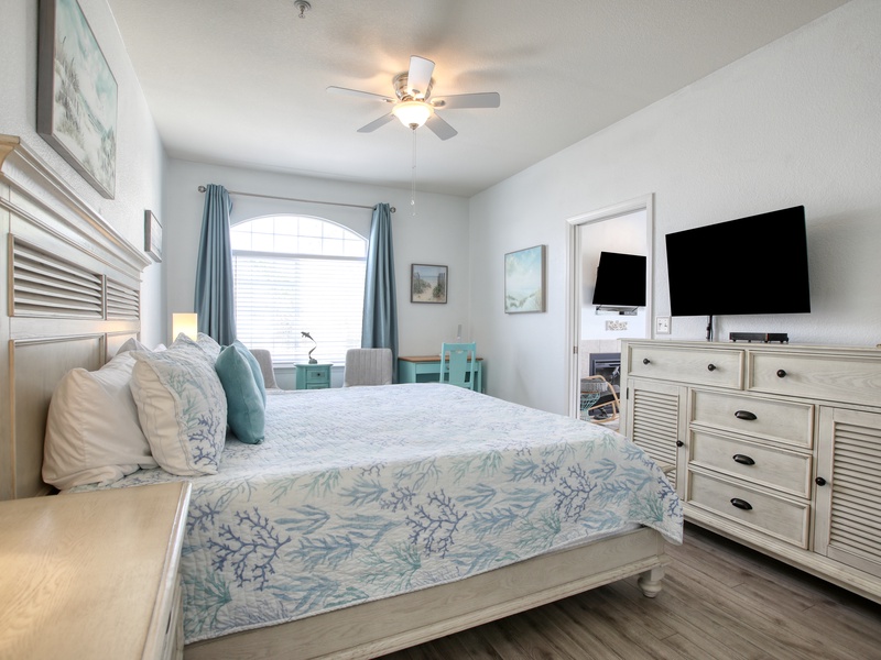 The bedroom features a comfy king bed, perfect for a restful night after a day of beach adventures.