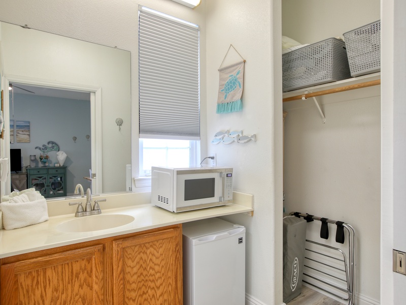 Compact kitchenette has a mini fridge, microwave, and kcup coffee maker—perfect for quick beachside bites.
