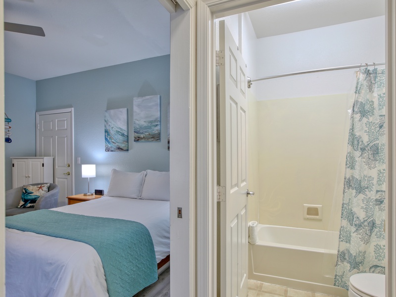 The bathroom comes complete with a tub/shower combo, a vanity, hair dryer, and fresh bath towels—everything you need to refresh after a day at the beach.