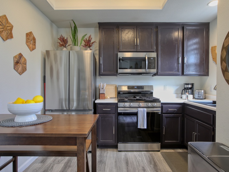 The fully equipped kitchen has a refrigerator, stove and oven, microwave, coffee maker, and dish ware—everything you need to whip up meals or enjoy a fresh cup of coffee before heading to the beach. 