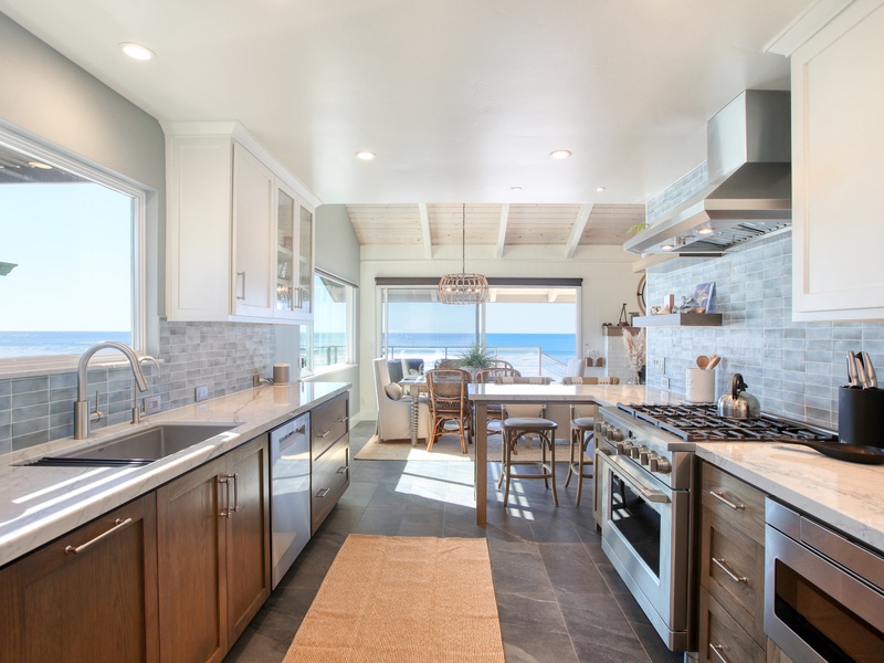 This beautifully remodeled kitchen is filled with an abundance of natural light and designed to be both spacious and welcoming, allowing multiple cooks to comfortably prepare meals together.
