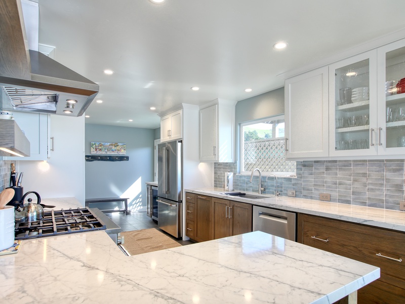 Step into this stunning beach house kitchen with chef-grade appliances, granite countertops, and custom cabinetry. Bright, functional, and fully stocked for your stay!