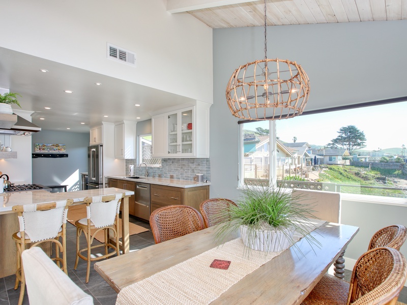 Coastal gourmet kitchen, completely remodeled in 2026 and equipped with chef-grade appliances, granite countertops, and custom cabinetry. Designed for both style and function, this bright and airy space is fully stocked with everything you need to prepare meals and entertain with ease. Pantry items not included.