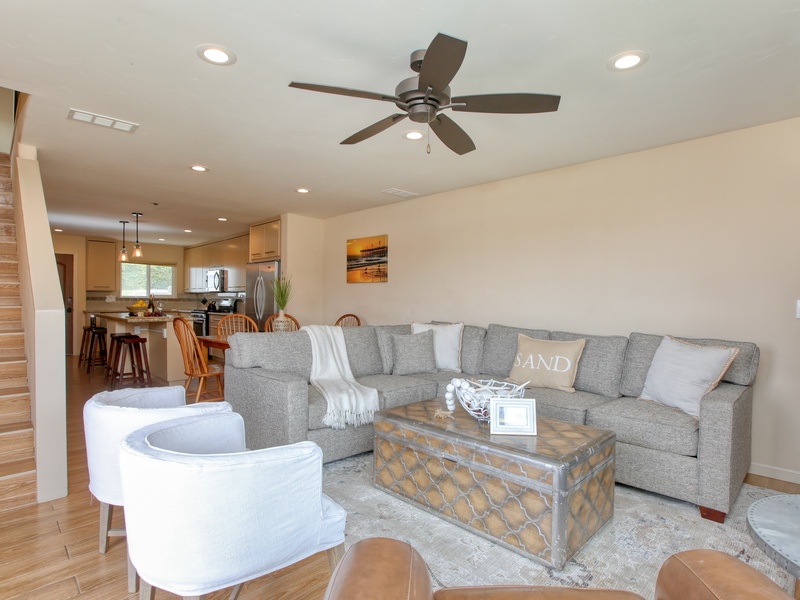 Ground level has a kitchen with a stone island and barstools, dining for four, and a cozy living area with a fireplace, half-bath and washer/dryer. Upstairs are the two bedrooms — your perfect beachy retreat!