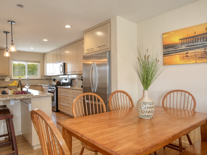Seating for four at the dining table plus four bar stools at the kitchen island.