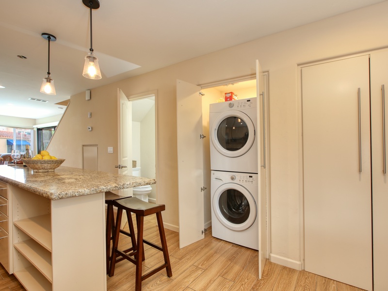 Tucked just off the kitchen is a half bathroom and a washer and dryer for your convenience.