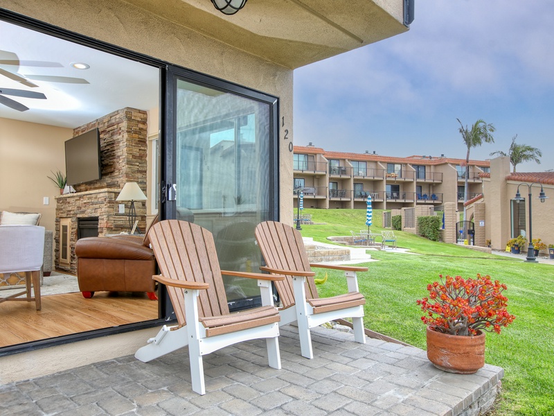 Step out to the back patio and soak up the coastal vibe — the perfect spot to sip your morning coffee or unwind with evening sunsets. Beyond the lush green lawn, you’ll find the community pool and hot tub, just steps away for a refreshing dip or a relaxing soak.