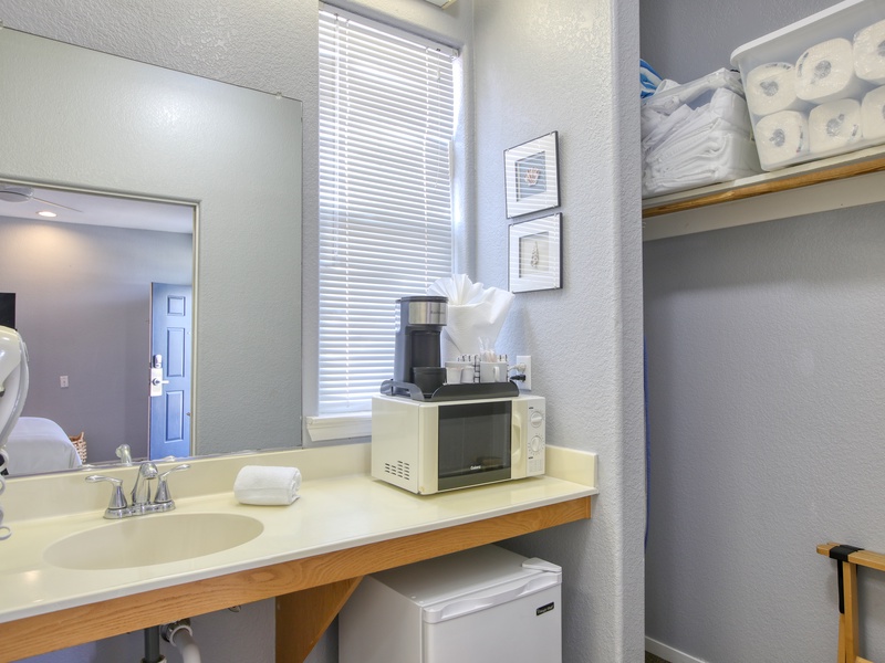 Compact kitchenette has a mini fridge, microwave, and kcup coffee maker—perfect for quick beachside bites.