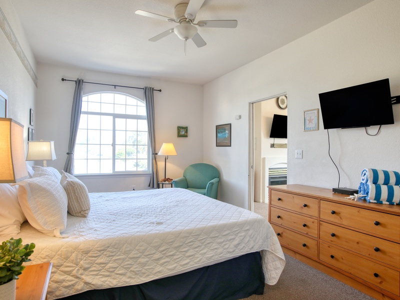The bedroom features a comfy king bed, perfect for a restful night after a day of beach adventures.