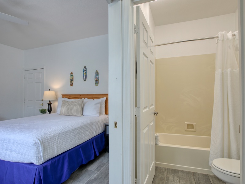 The bathroom comes complete with a tub/shower combo, a vanity, hair dryer, and fresh bath towels—everything you need to refresh after a day at the beach.