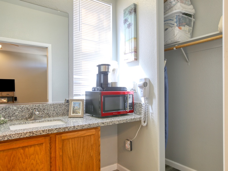 Compact kitchenette has a mini fridge, microwave, and kcup coffee maker—perfect for quick beachside bites.