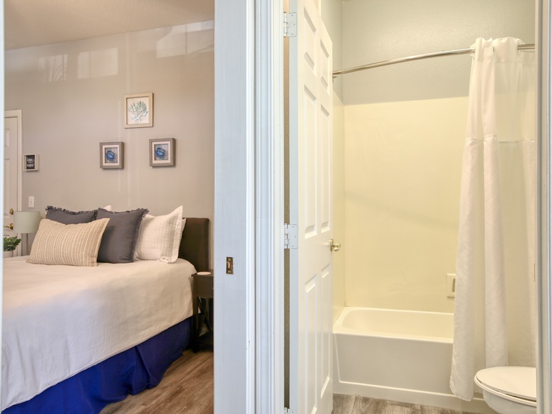 The bathroom comes complete with a tub/shower combo, a vanity, hair dryer, and fresh bath towels—everything you need to refresh after a day at the beach.
