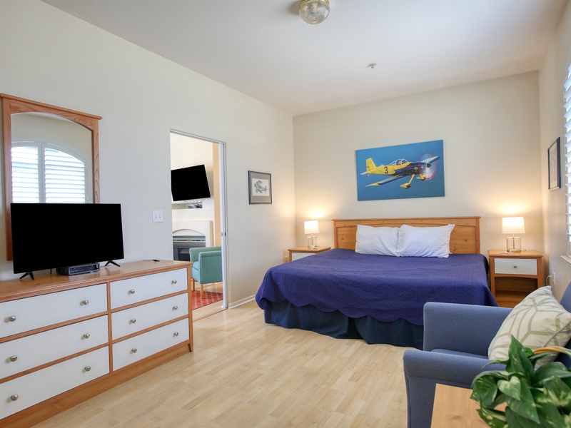 A spacious bedroom with a luxurious king bed, offering comfort and relaxation just moments from the beach.