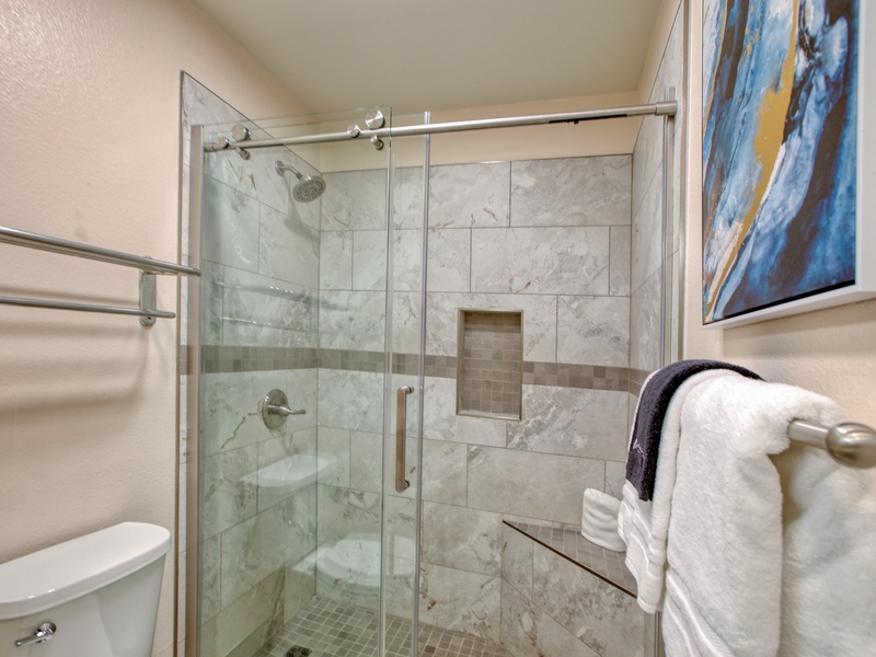 Everything is brand new! Enjoy the sleek lines of our recent remodel, featuring premium tiling and a spacious walk-in shower. The light, airy coastal tones ensure a bright and refreshing start to your morning.