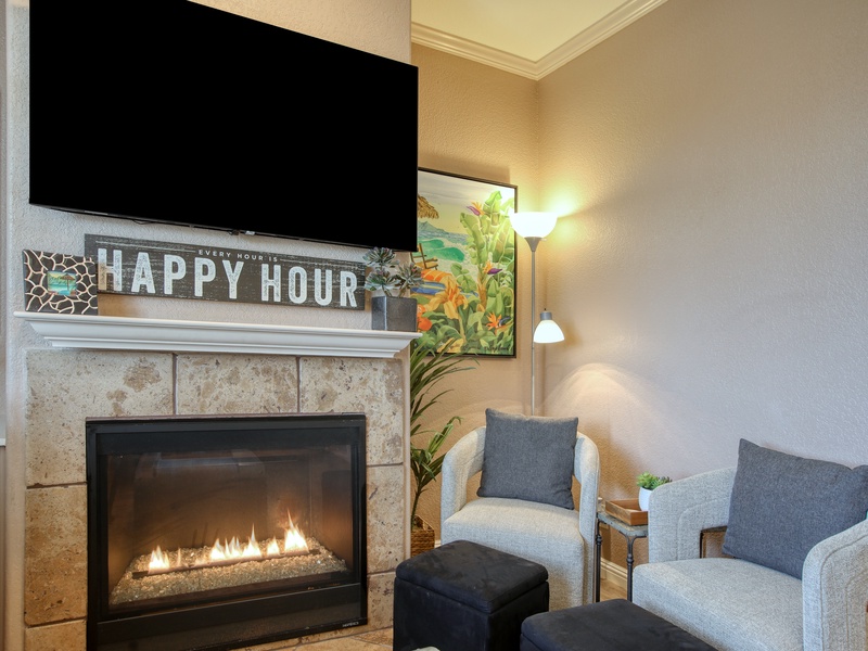 It’s Always 5 O'Clock Here The heart of our living room is built for good times. Gather around the cozy fireplace and let the "Happy Hour" sign be your official reminder that vacation has begun!