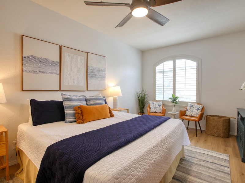 The bedroom features a comfy king bed, perfect for a restful night after a day of beach adventures.
