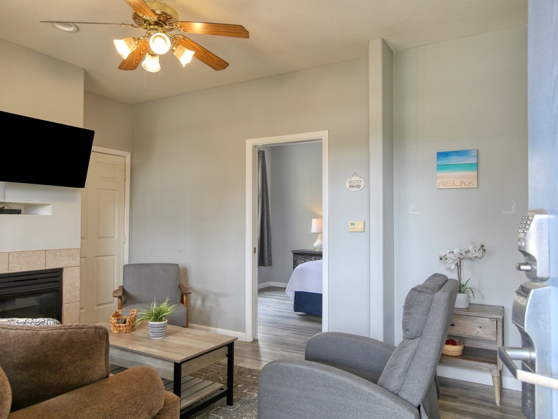 This inviting living room features comfortable seating, a queen sized sofa sleeper, and a cozy fireplace.  