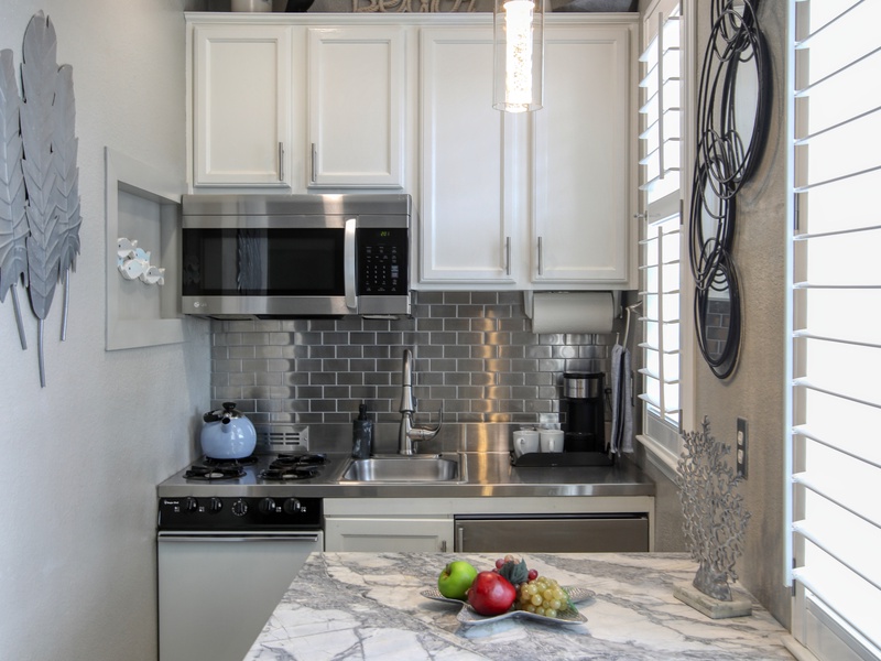Enjoy the only studio condo at Pacific Plaza Resort with a full compact kitchen! Equipped with a microwave, stovetop, oven, mini refrigerator, K-Cup coffee maker, and dishware, it’s perfect for whipping up quick bites or cozy meals after a day at the beach.