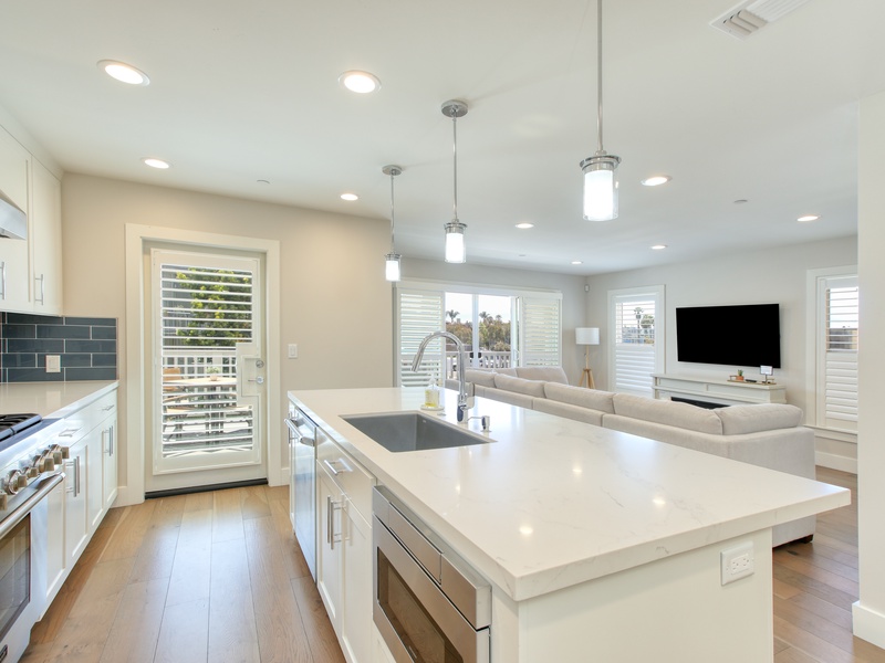 An airy open-concept living space bathed in natural light invites you to unwind and connect. 