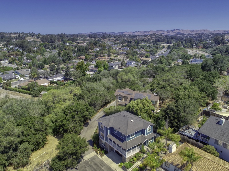 Paseo del Sol: Your Tranquil Base. The aerial perspective shows our private setting in a quiet community, adjacent to a natural live oak and native green belt. We value our neighbors; please respect quiet hours from 10 PM to 7 AM. Parking is limited to four vehicles maximum (two in the garage, two in the driveway). RV, motorhome, or trailer parking is strictly prohibited.