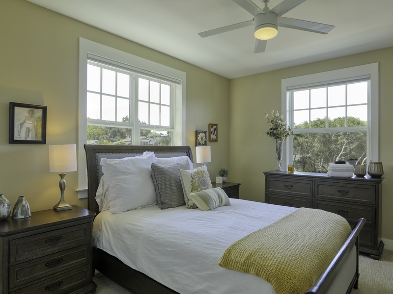 Third Bedroom Escape: Designed for rest after sunny beach days, this second-level room offers a cozy queen mattress with crisp, white linens and a stylish headboard. A full bathroom is easily accessible right next door.