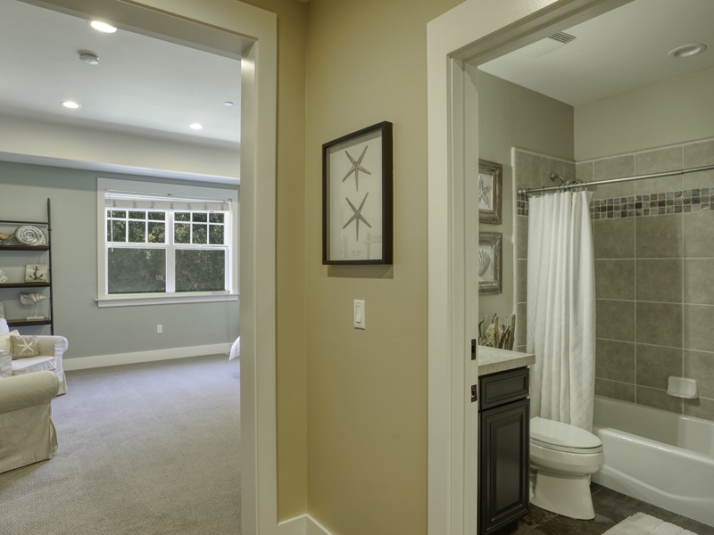 Ensuite Bath Retreat: This bathroom offers a calming space to refresh after beach adventures. Amenities include a tub/shower combo and vanity, along with plush, absorbent white towels and quality soaps and shampoo.