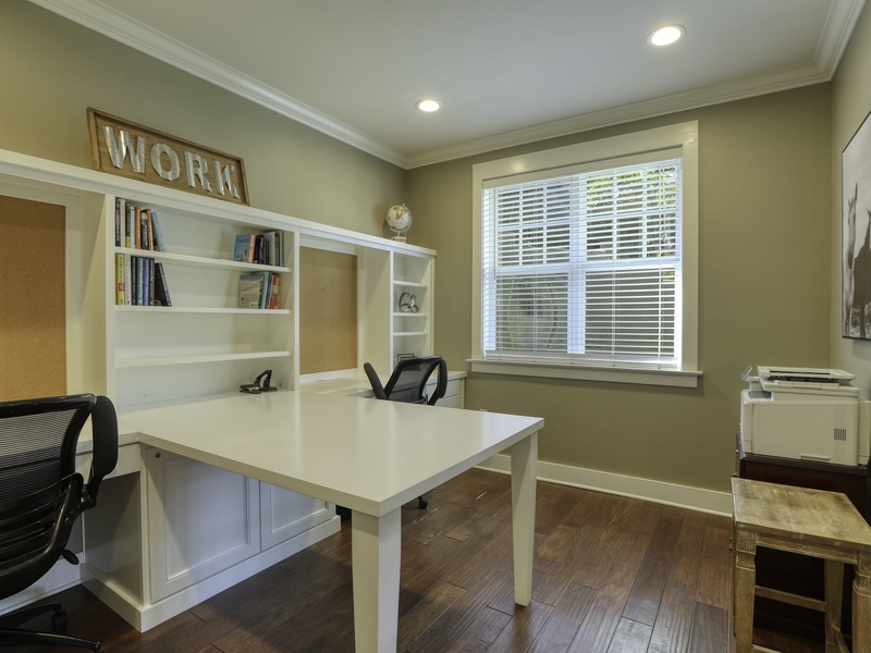 A convenient, built-in home office located across the formal living room (off the foyer). Featuring a two-person desk and an accessible printer—perfect for remote work or printing essentials.