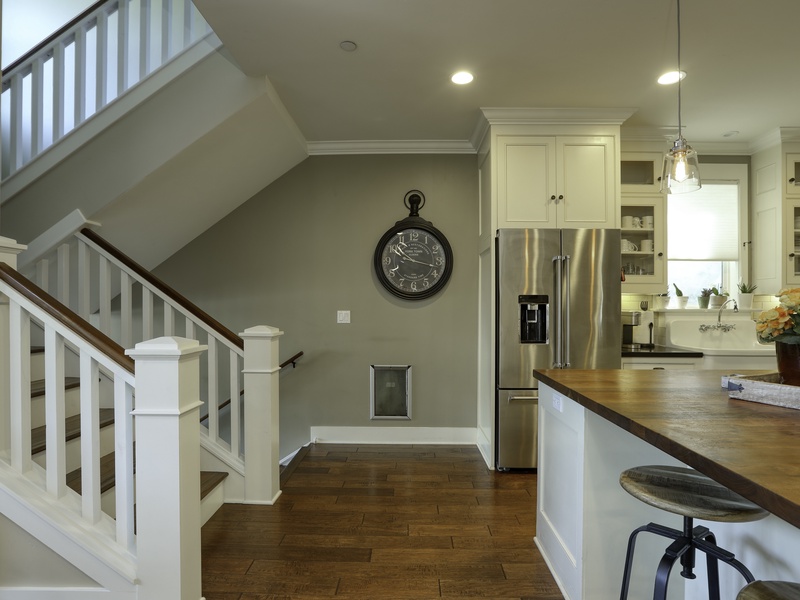 The central stairwell leads guests up to the second floor, home to four spacious bedrooms.