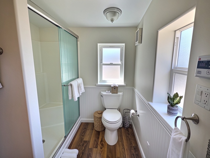 There is one bathroom with a large shower.